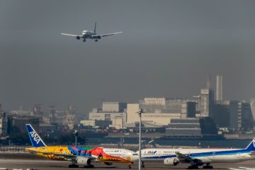 ‘Killing three birds with one stone’! Thanks to some lucky timing I was able to capture three airplanes within a single shot. While the top airplane is landing the other two are in ‘taxi’. Please also note the colorful airplane on the bottom left!